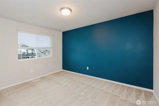 an empty room with wall and painting on the wall