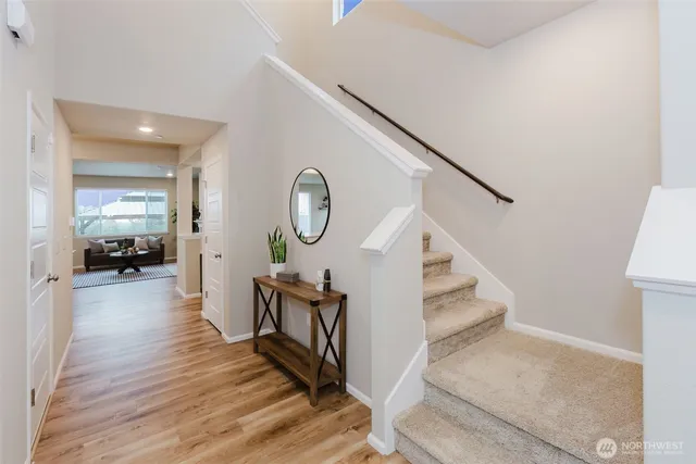 a view of a livingroom with wooden floor and furniture