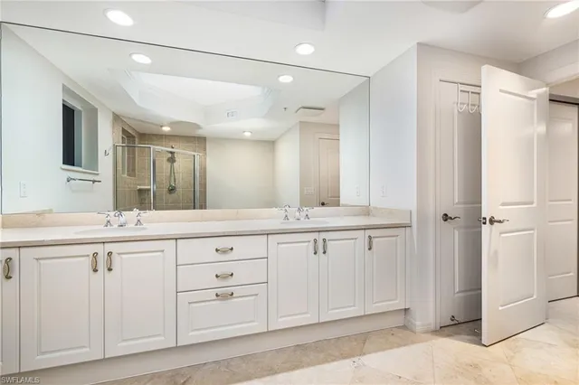 a bathroom with a granite countertop sink mirror and double