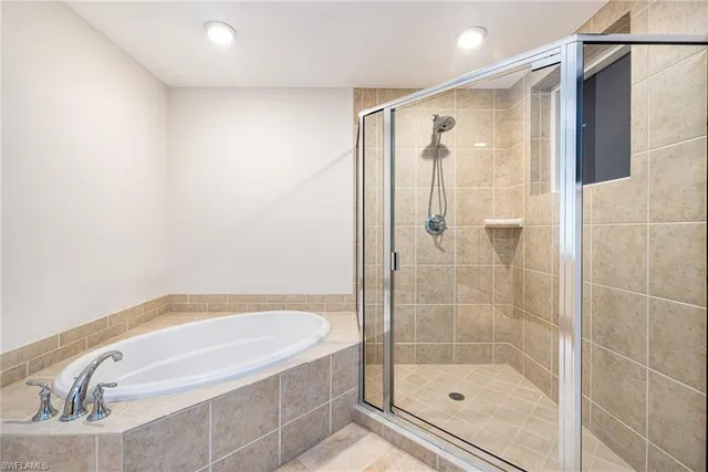 a bathroom with a bathtub and a shower