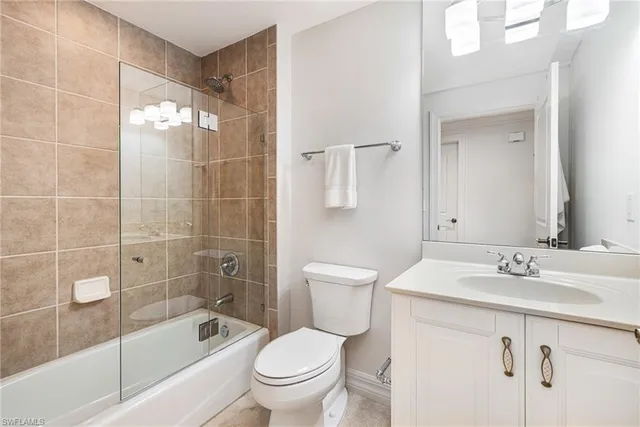 a bathroom with a sink mirror toilet and bathtub