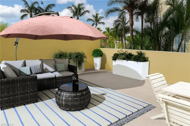 a view of a patio with couches and potted plants