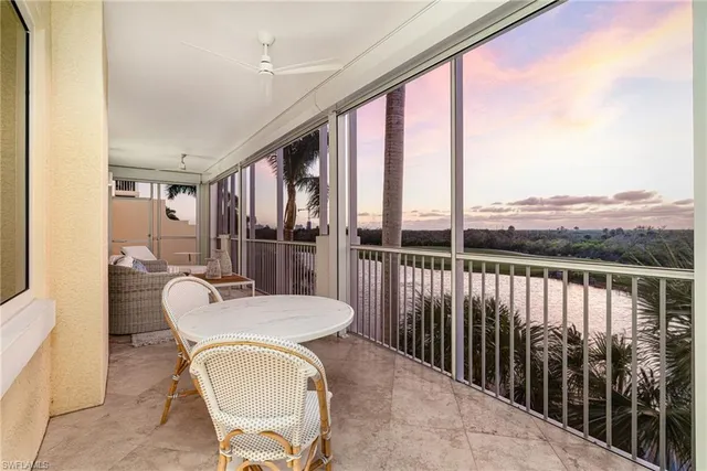 a balcony with table and chairs