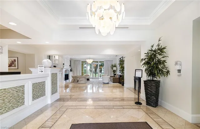 a lobby with furniture and chandelier