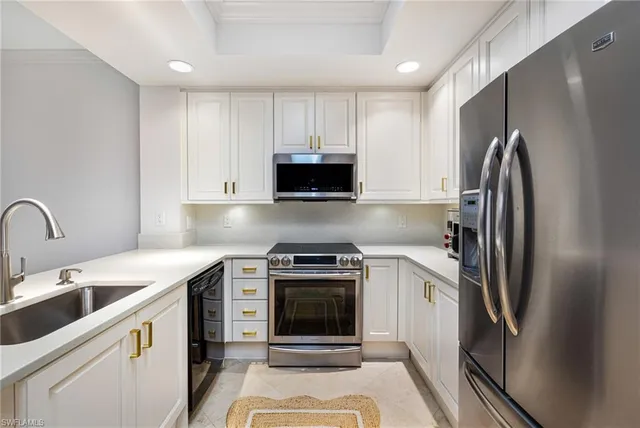 a kitchen with a stove sink and refrigerator