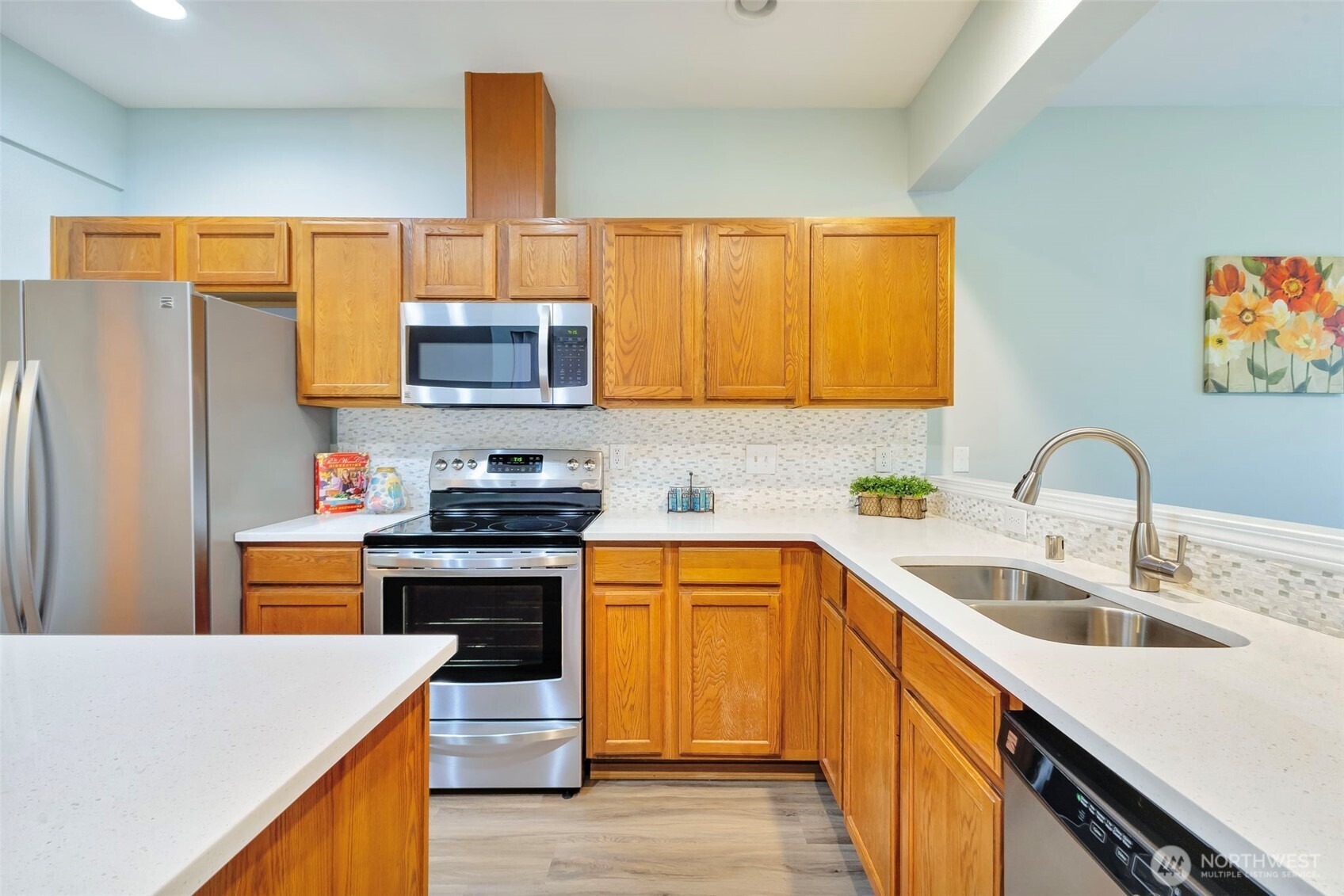 5319 147th St Court East, Unit 5 Tacoma, WA 98446 - Photo 11 of 30 a kitchen with stainless steel appliances a stove a sink a microwave and wooden cabinets
