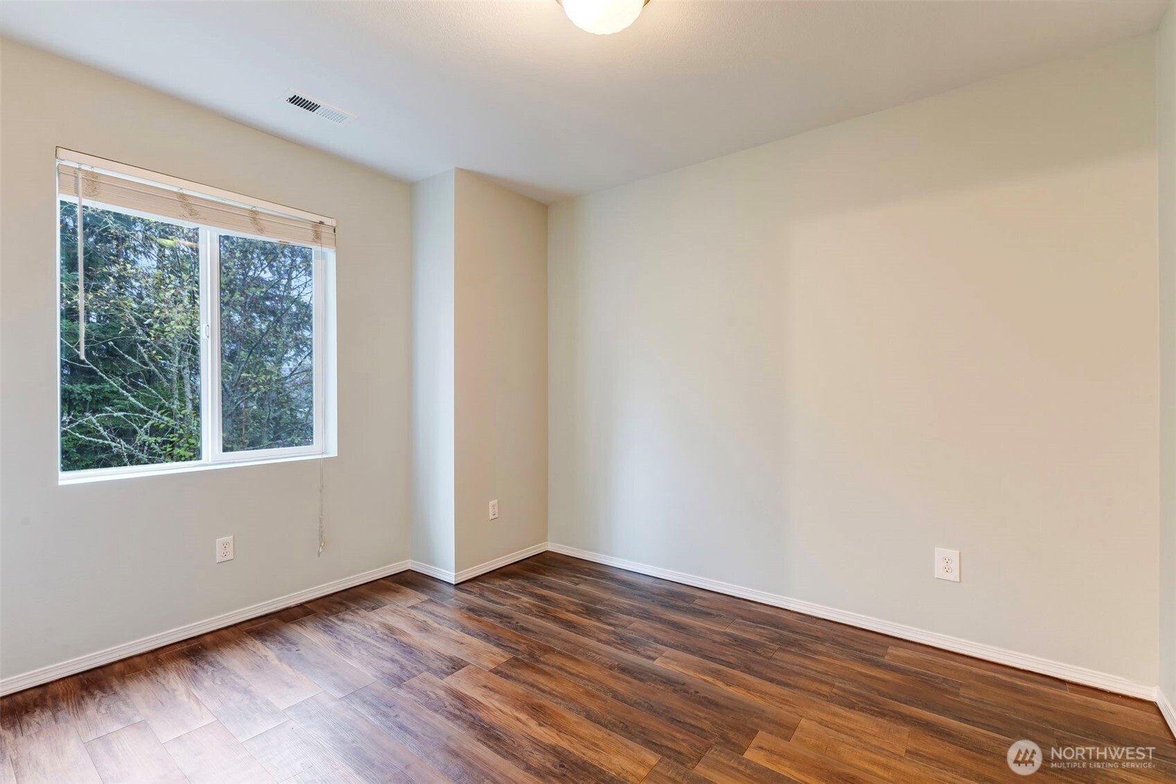 5319 147th St Court East, Unit 5 Tacoma, WA 98446 - Photo 16 of 30 a view of an empty room with wooden floor and a window
