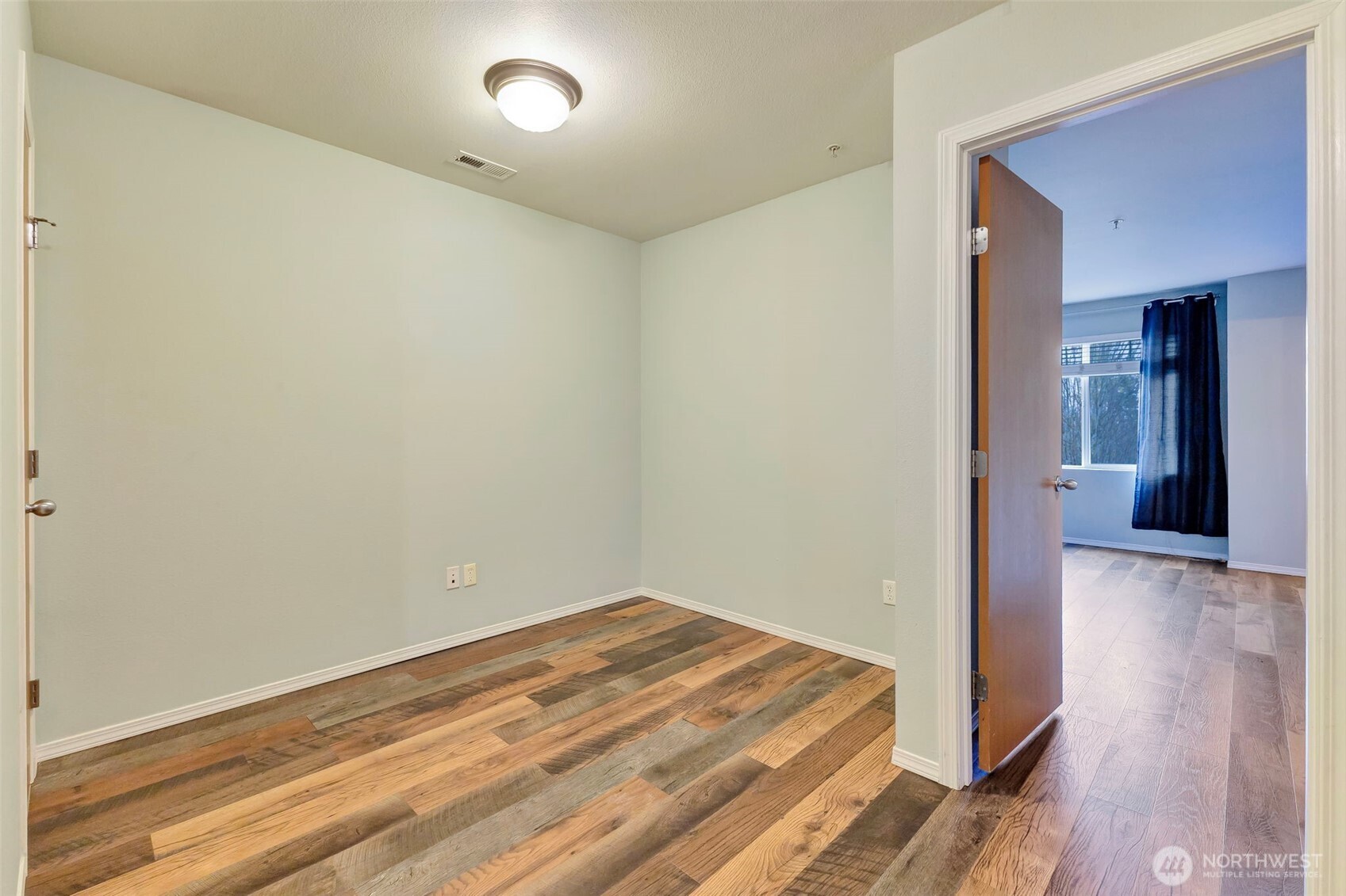 5319 147th St Court East, Unit 5 Tacoma, WA 98446 - Photo 19 of 30 a view of a room with wooden floor and a bathroom