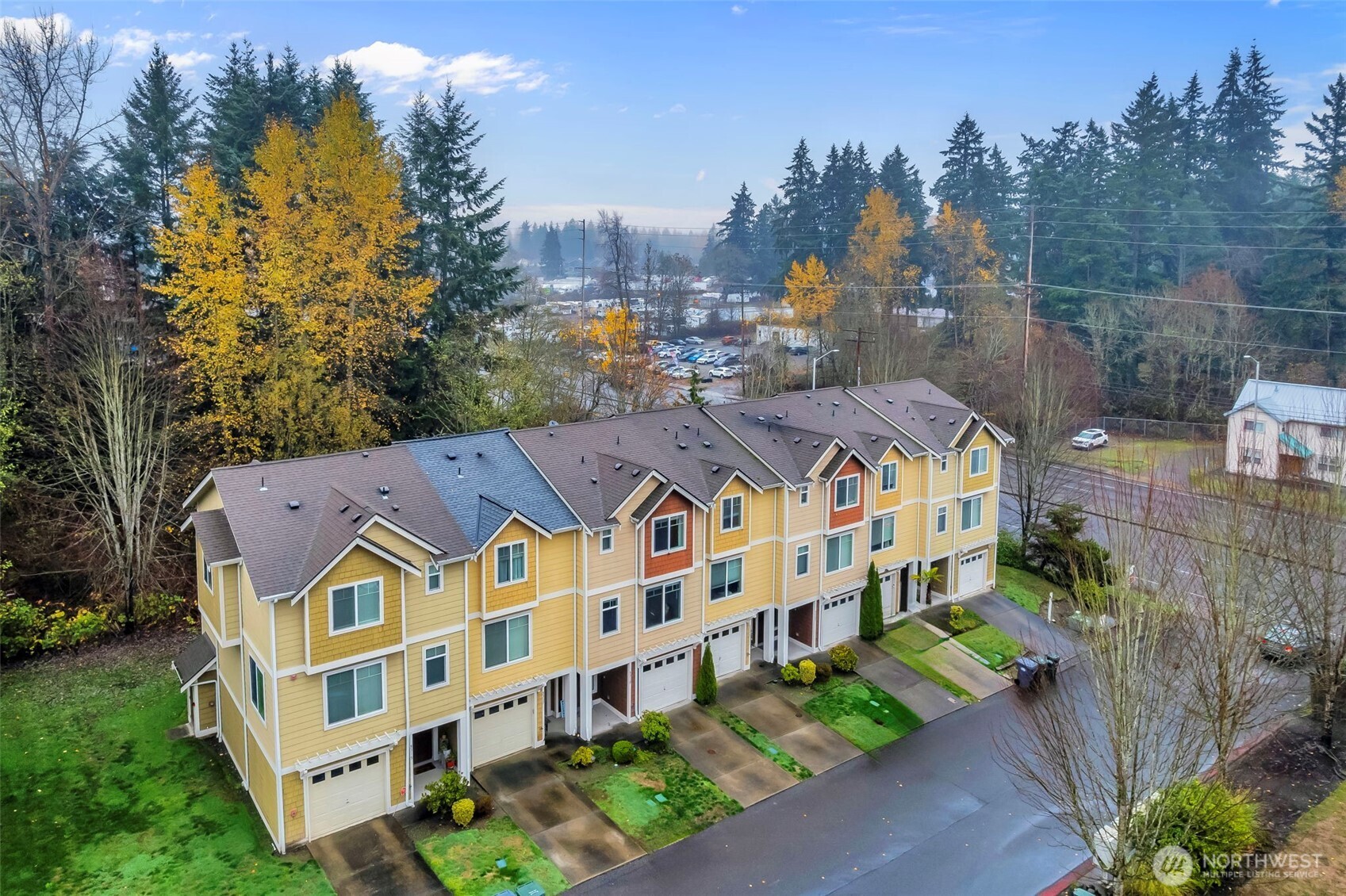 5319 147th St Court East, Unit 5 Tacoma, WA 98446 - Photo 2 of 30 a large building with a big yard and large trees