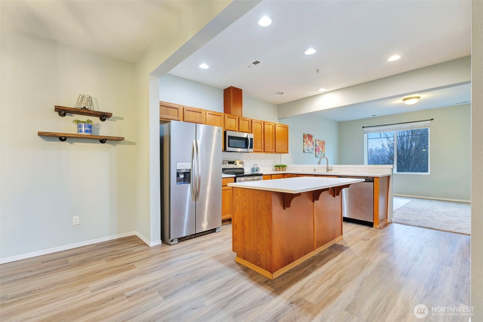 5319 147th St Court East, Unit 5 Tacoma, WA 98446 - Photo 5 of 30 a kitchen with stainless steel appliances granite countertop a refrigerator a sink and a stove