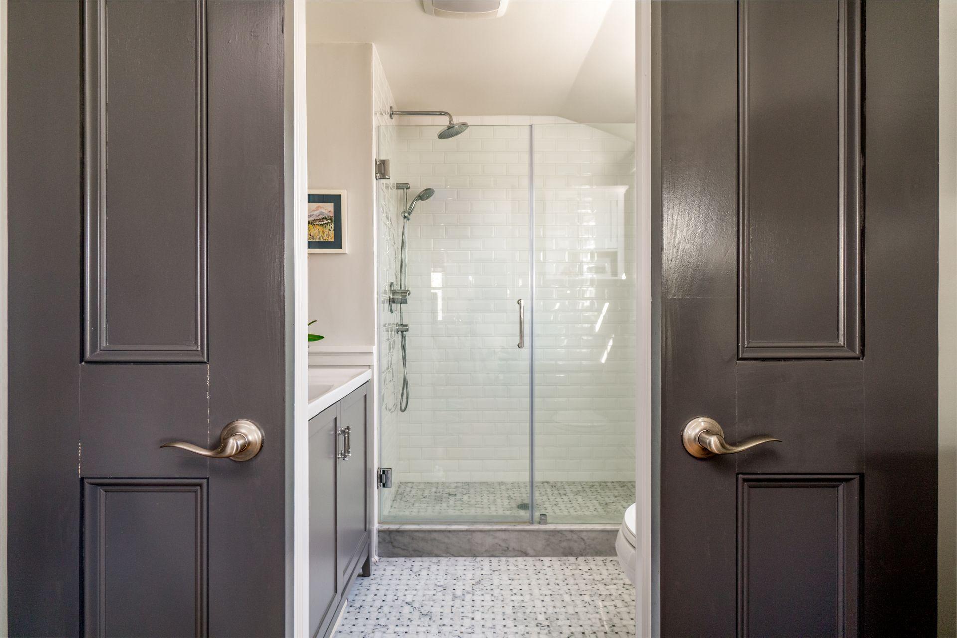 17 Steeple Top Road Rowayton, CT 06853 - Photo 25 of 37 a bathroom with a glass shower door