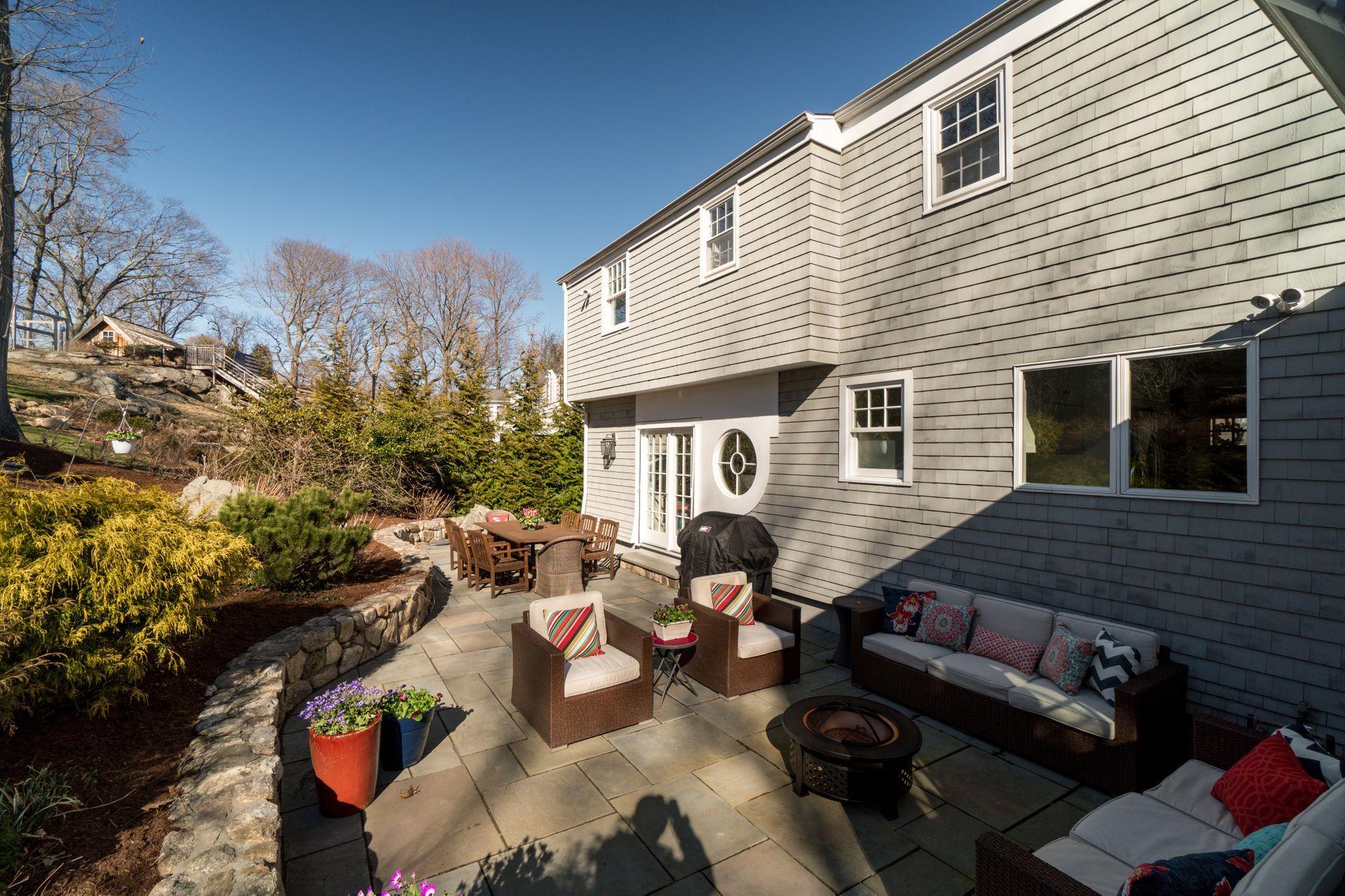 17 Steeple Top Road Rowayton, CT 06853 - Photo 30 of 37 a view of a patio with couches table and chairs and potted plants