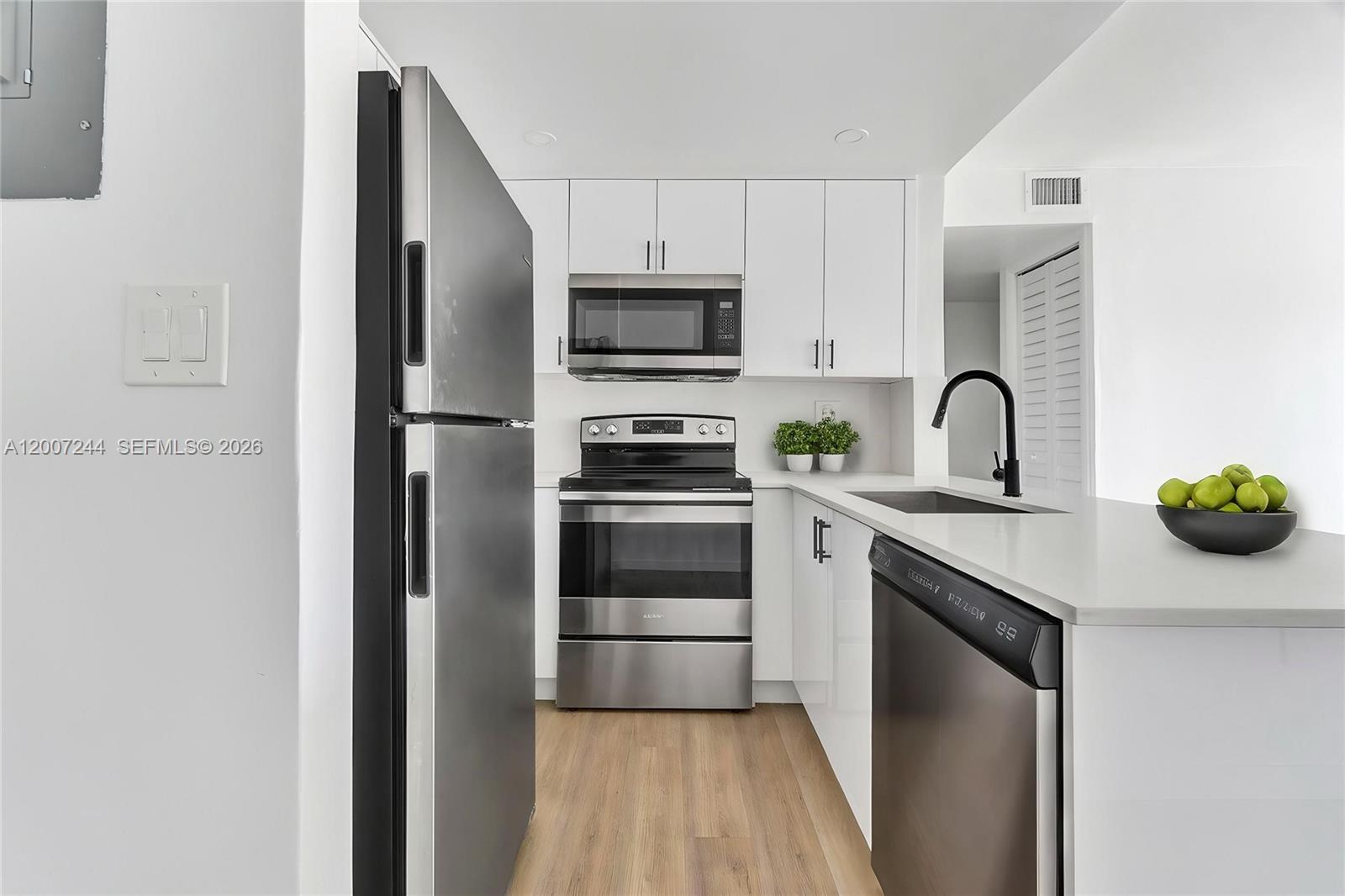 a kitchen with a refrigerator sink and stove