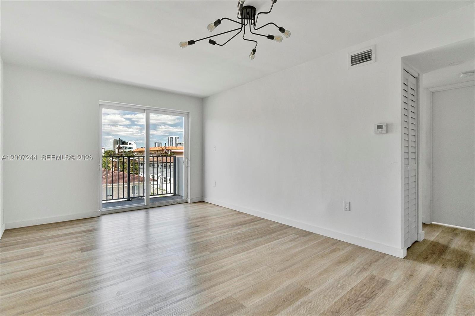 620 Southwest 10th Street, Unit 301 Miami, FL 33130 - Photo 7 of 20 wooden floor in an empty room with a window