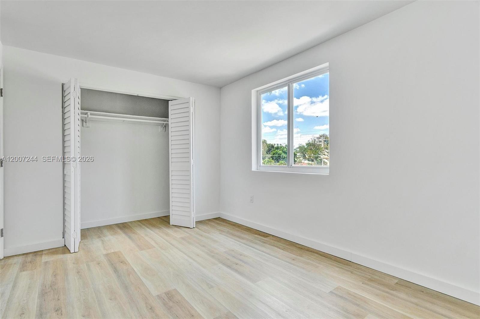 620 Southwest 10th Street, Unit 301 Miami, FL 33130 - Photo 9 of 20 an empty room with wooden floor and windows