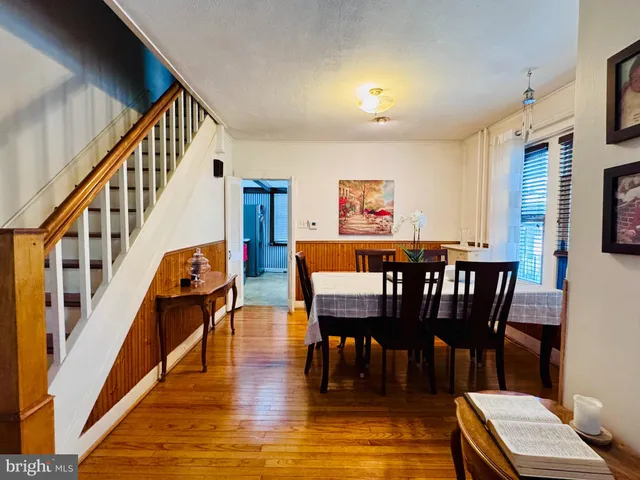 a dining room with furniture a rug and wooden floor