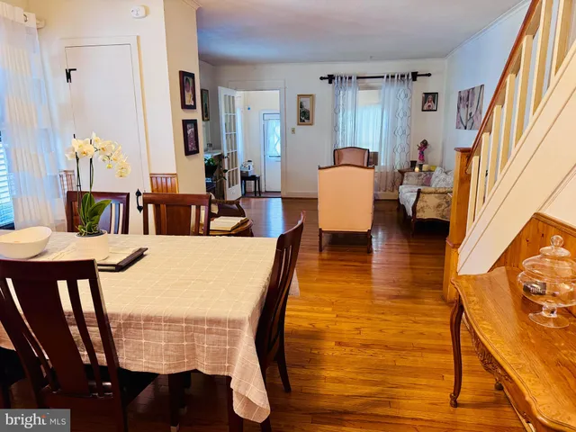 a dining room with furniture and wooden floor