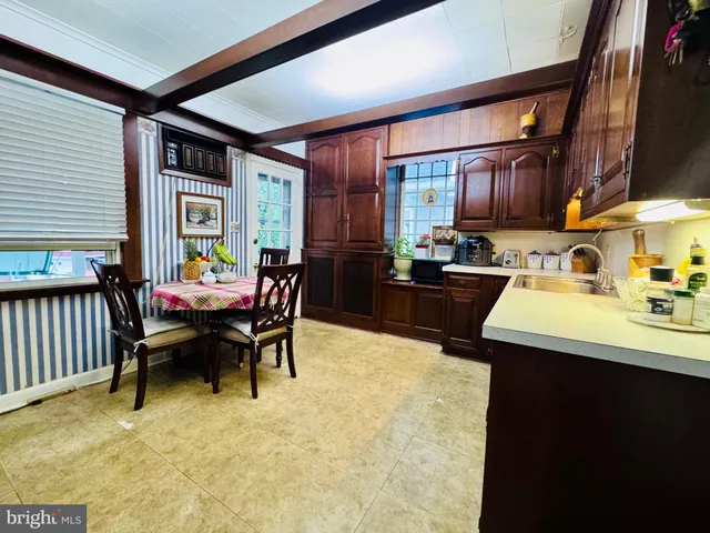 a dining room with furniture and large windows