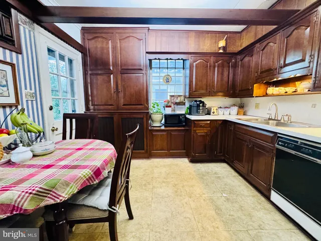 a kitchen with a sink and wooden cabinets