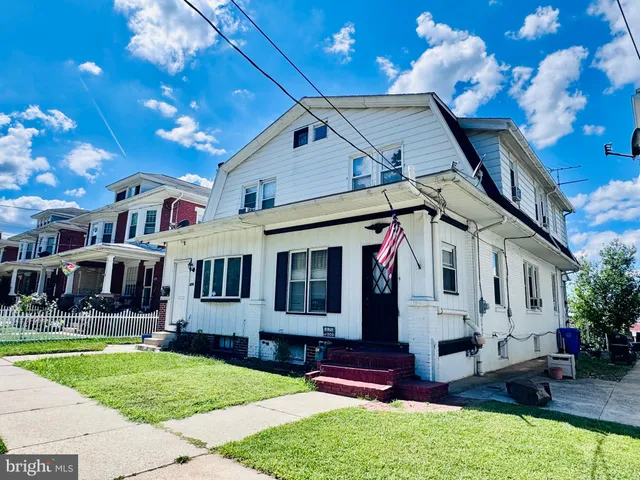 a front view of house with yard and outdoor seating