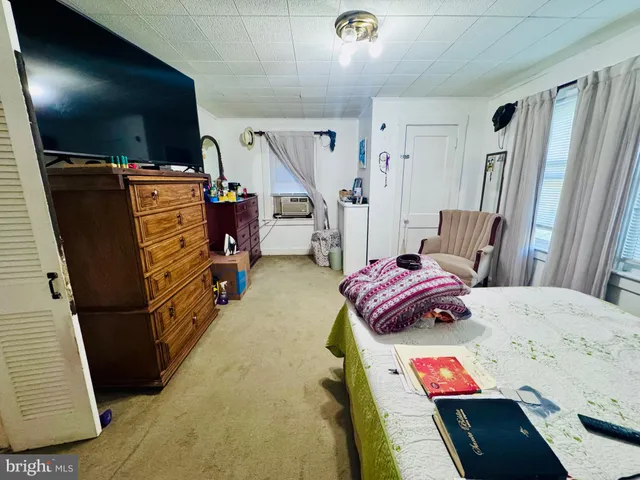 a bedroom with furniture and a flat screen tv