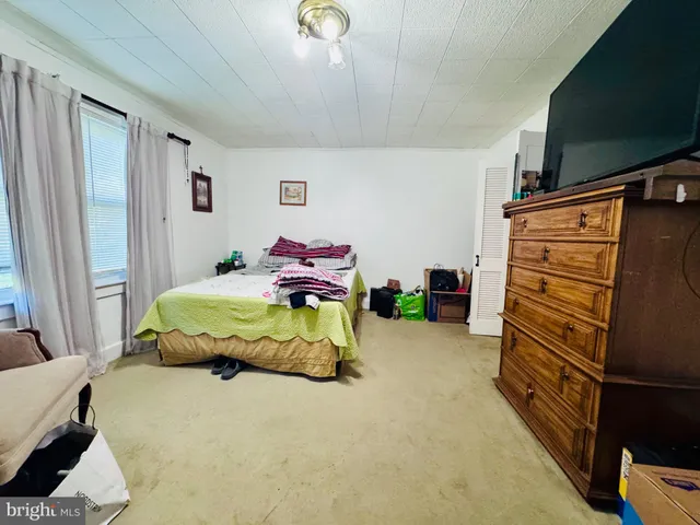 a bedroom with a bed and a flat tv screen