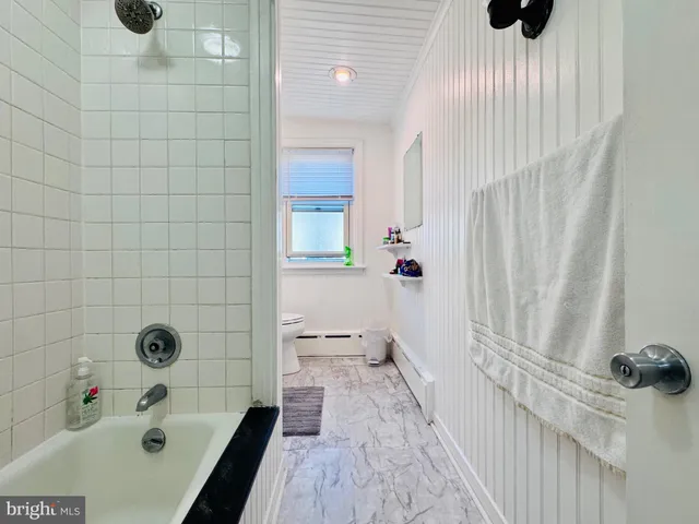 a bathroom with a bathtub and shower