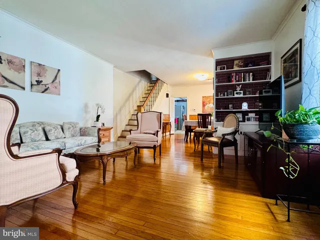 a living room with furniture and book shelf