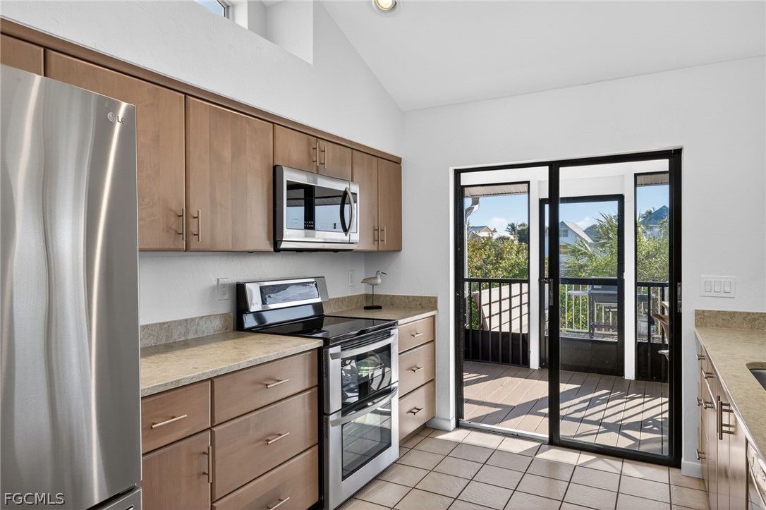 4562 Bowen Bayou Road Sanibel, FL 33957 - Photo 12 of 38 a kitchen with granite countertop a refrigerator stove top oven and sink
