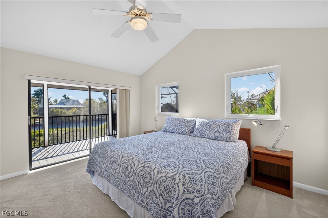 4562 Bowen Bayou Road Sanibel, FL 33957 - Photo 15 of 38 a bedroom with a large bed and a chandelier