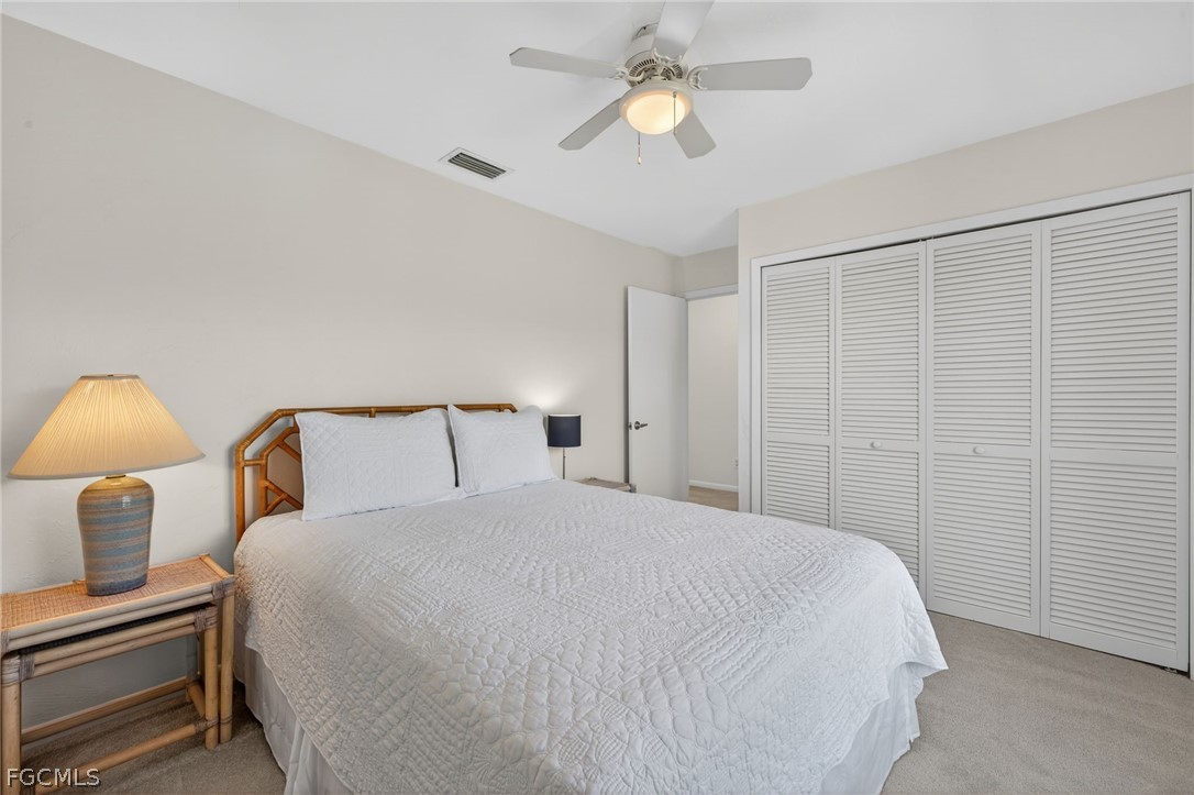 4562 Bowen Bayou Road Sanibel, FL 33957 - Photo 19 of 38 a bedroom with a bed and a lamp