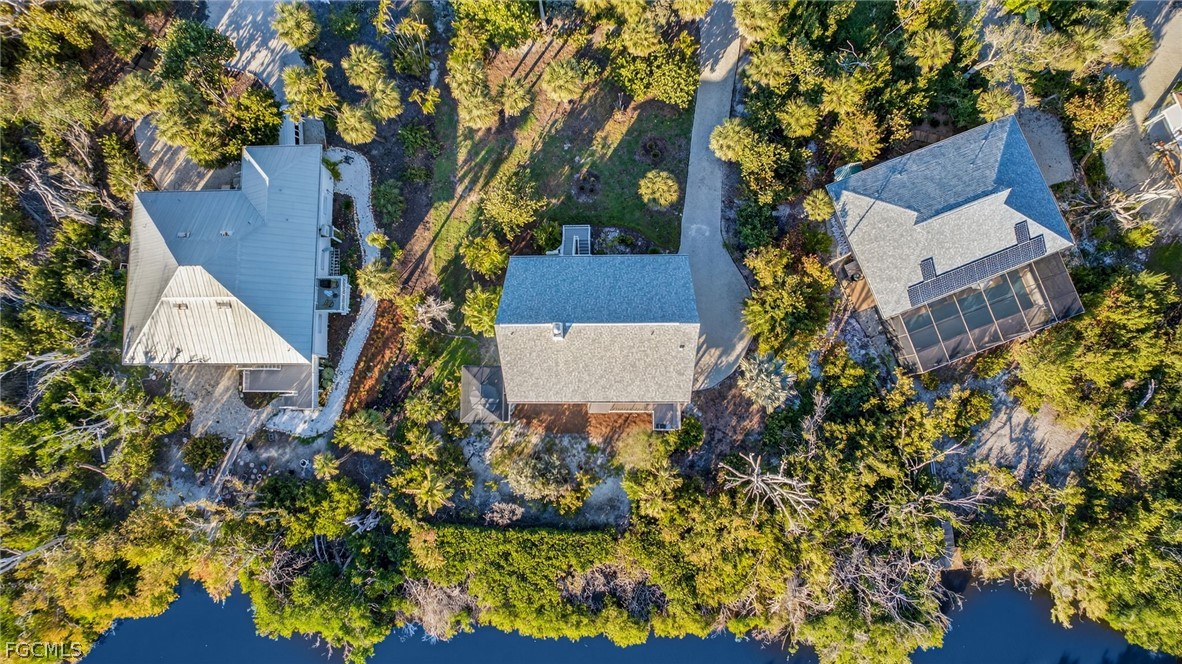 4562 Bowen Bayou Road Sanibel, FL 33957 - Photo 25 of 38 front view of a house with a yard and garden