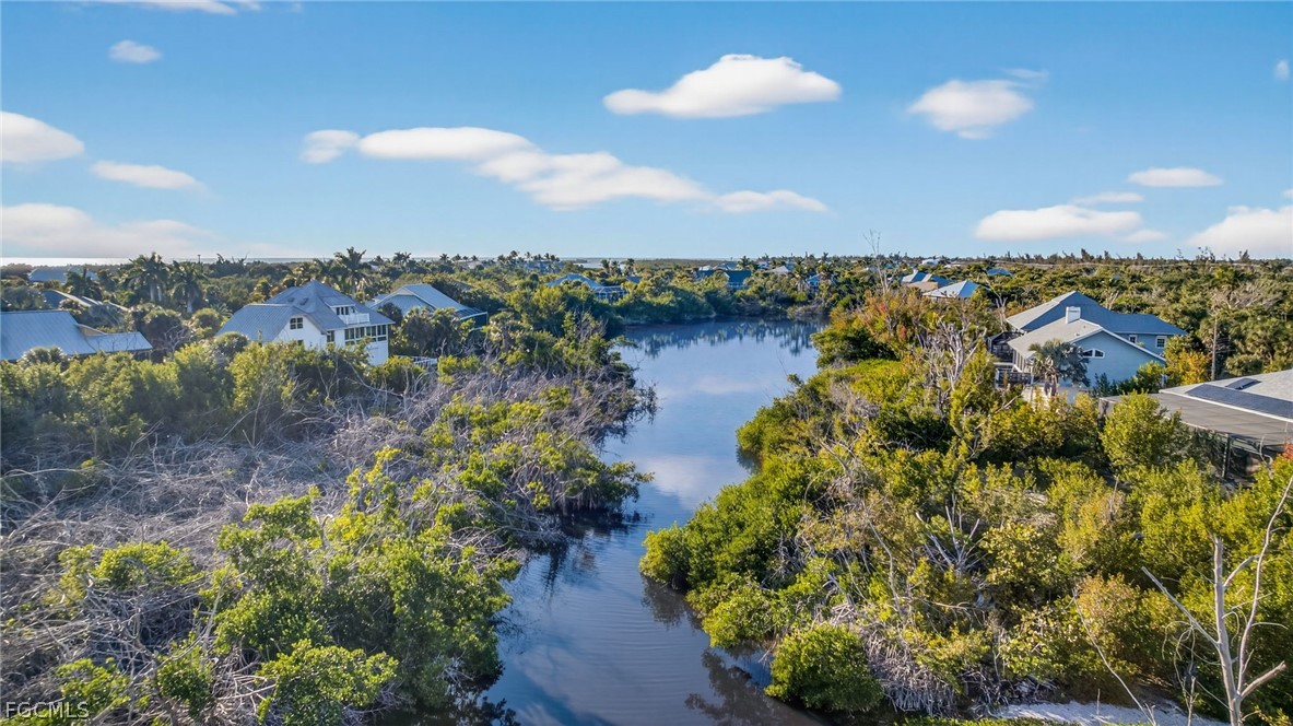 4562 Bowen Bayou Road Sanibel, FL 33957 - Photo 6 of 38 an aerial view of ocean with residential house with outdoor space