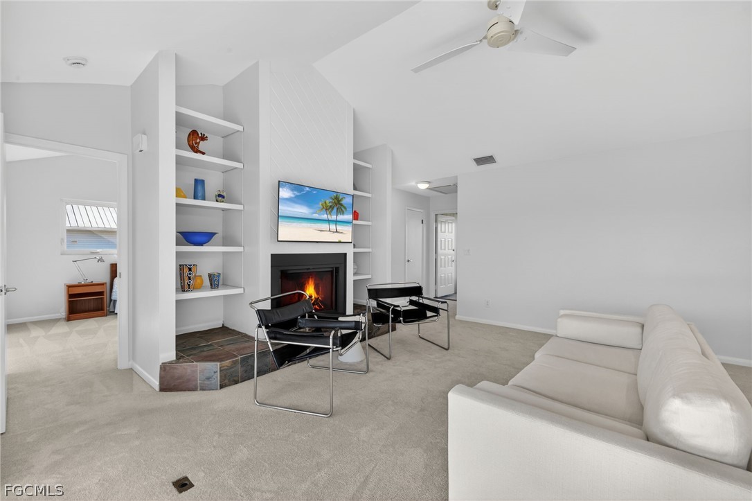4562 Bowen Bayou Road Sanibel, FL 33957 - Photo 9 of 38 a living room with furniture and a fireplace