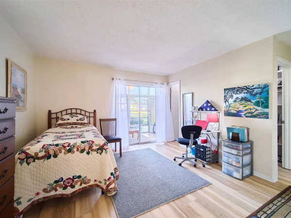 a bedroom with furniture and a wooden floor