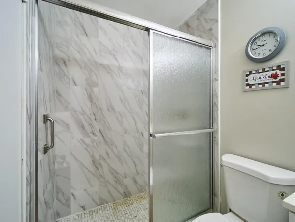 a bathroom with a shower and a toilet