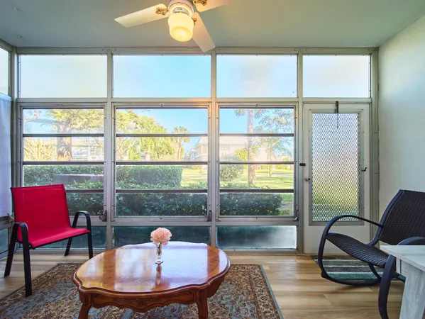 a living room with furniture a lamp and a window
