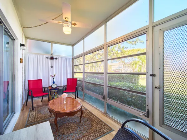 a living room with furniture a rug and a large window