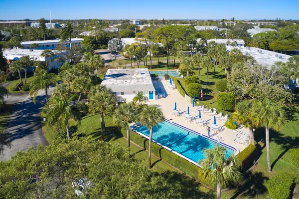 an aerial view of multiple houses with yard