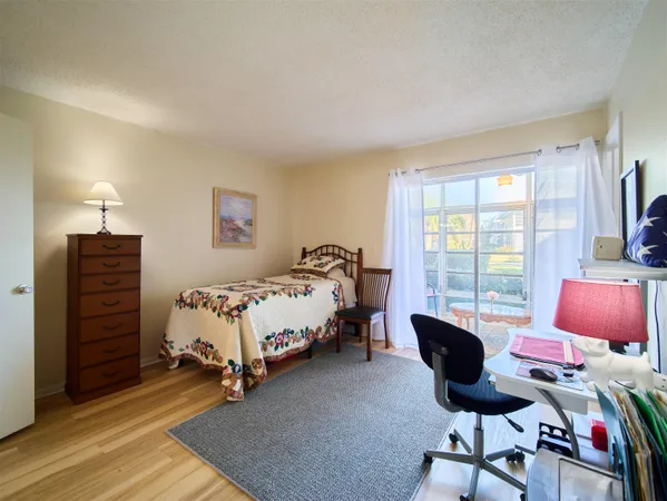 a bed room with a bed and a chair