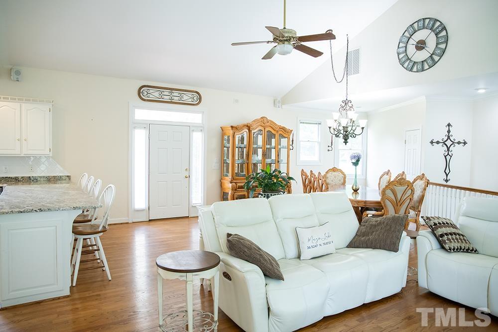 687 Ed Lester Road Roxboro, NC 27574 - Photo 17 of 63 a living room with furniture and a chandelier