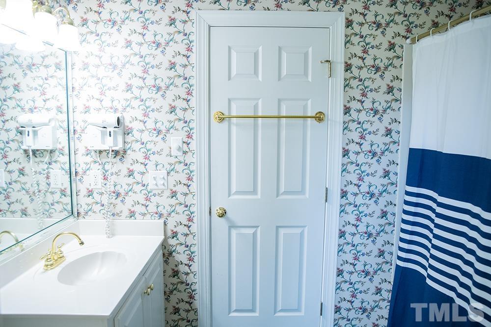 687 Ed Lester Road Roxboro, NC 27574 - Photo 42 of 63 a bathroom with a sink a vanity and a bathtub