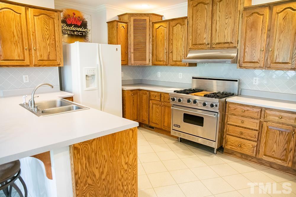 687 Ed Lester Road Roxboro, NC 27574 - Photo 48 of 63 a kitchen with stainless steel appliances a stove a sink and a refrigerator