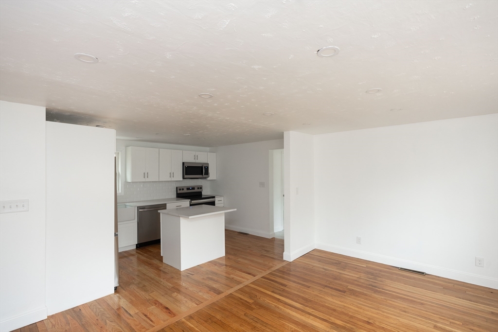 155 Southbridge Road Oxford, MA 01537 - Photo 11 of 39 a kitchen with granite countertop a stove and a refrigerator