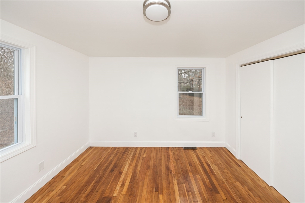 155 Southbridge Road Oxford, MA 01537 - Photo 15 of 39 an empty room with wooden floor and windows
