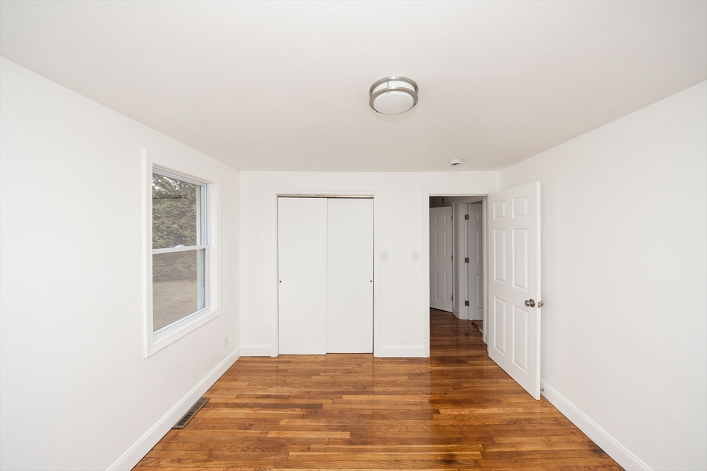 155 Southbridge Road Oxford, MA 01537 - Photo 16 of 39 a view of an empty room with wooden floor and a window