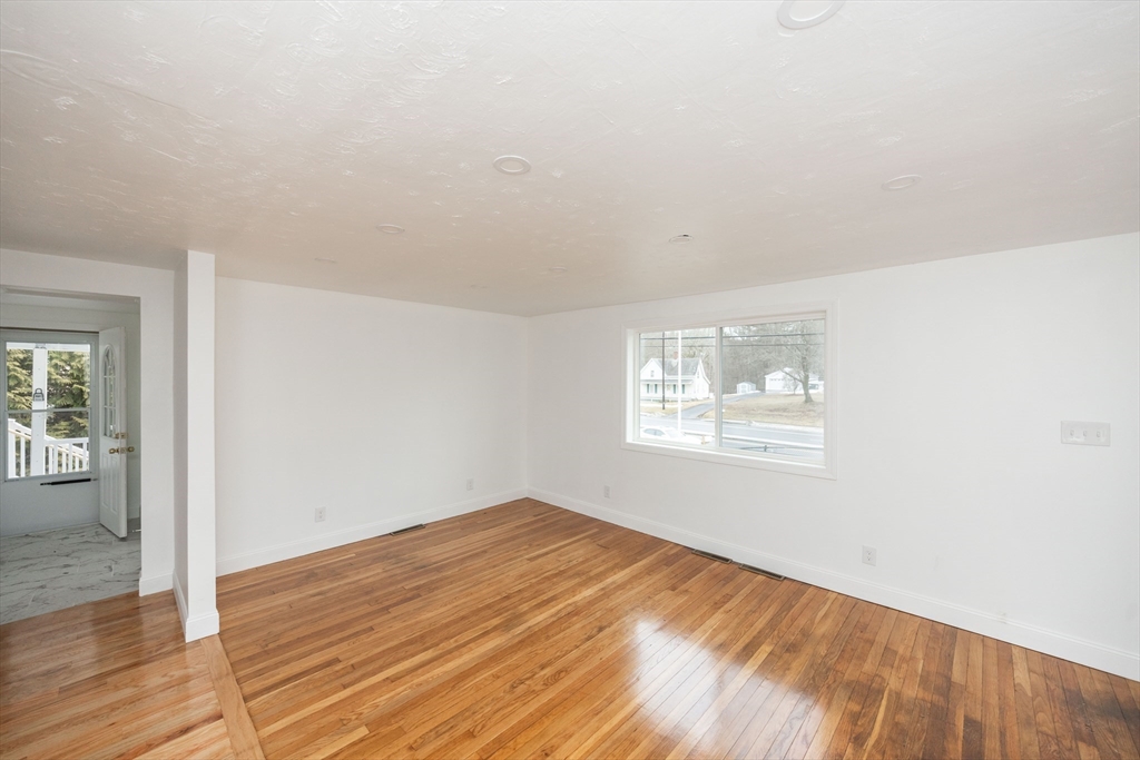 155 Southbridge Road Oxford, MA 01537 - Photo 30 of 39 an empty room with wooden floor and windows