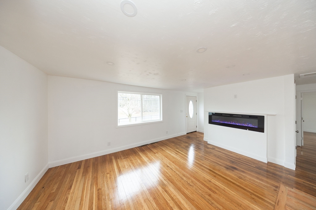155 Southbridge Road Oxford, MA 01537 - Photo 9 of 39 an empty room with wooden floor and windows