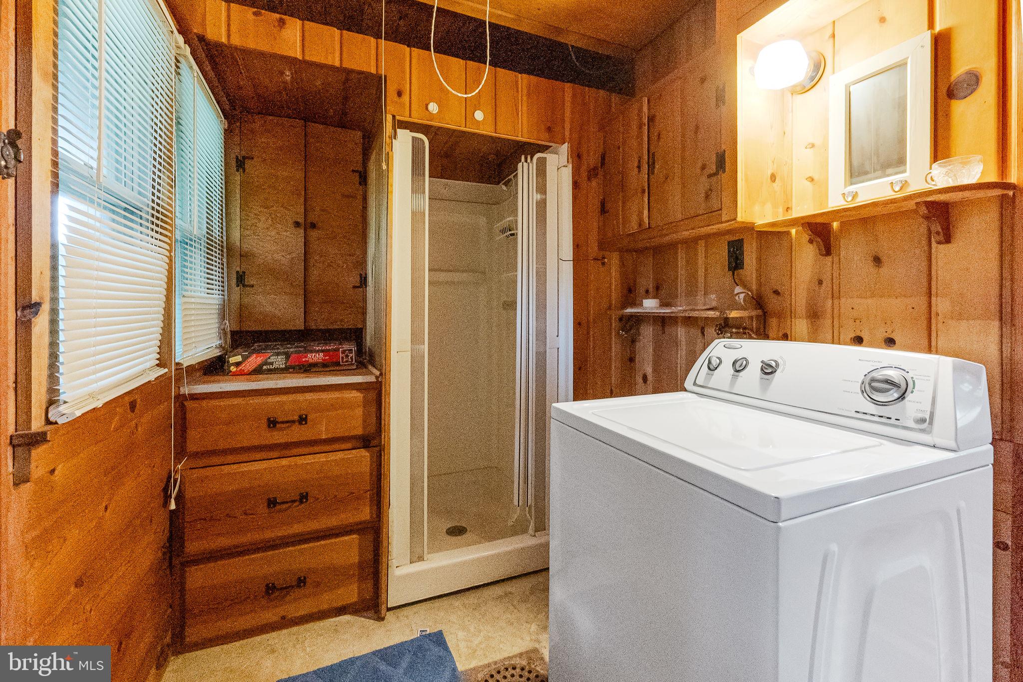 2138 Cedar Road Port Republic, MD 20676 - Photo 14 of 34 a view of washer and dryer with wooden cabinets
