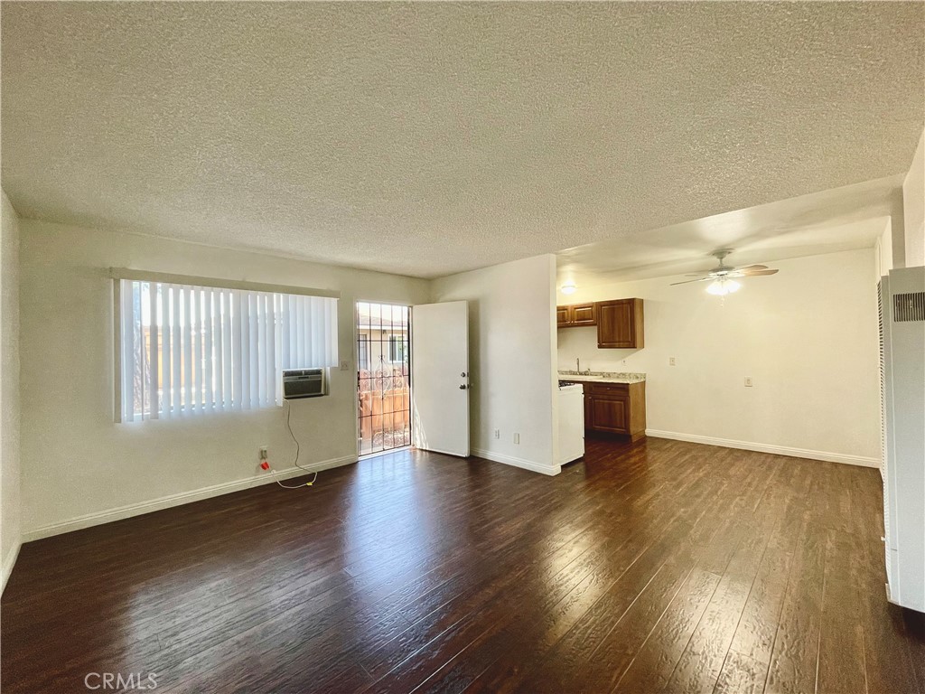 935 East Rte 66 Glendora, CA 91740 - Photo 3 of 10 a view of an empty room with a window and wooden floor